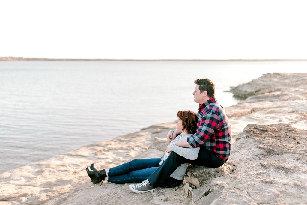 Sunset Engagement Session Sitting on the Rocks at Lake Grapevine