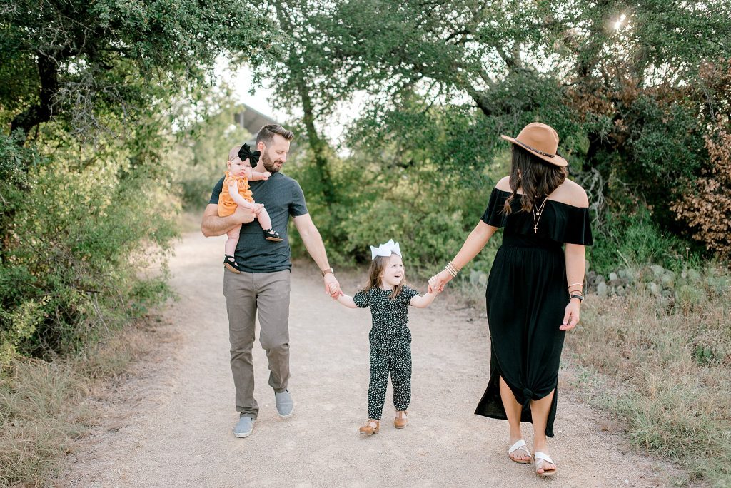 Family walking and laughing for family photos