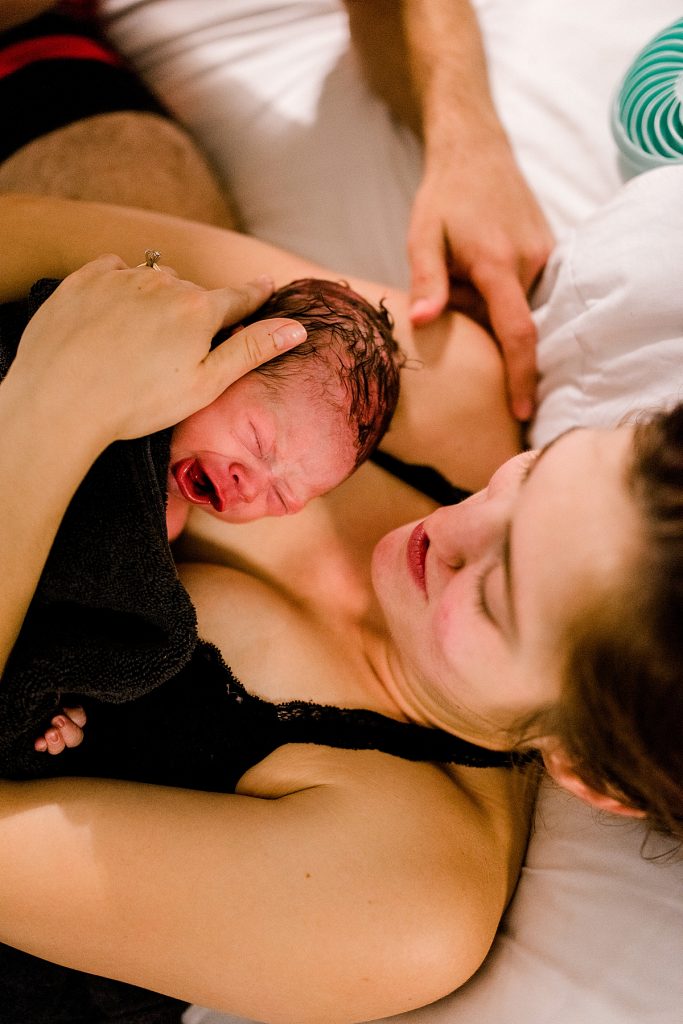 mom holding newborn after giving birth, baby Luke born at 6:01 am
