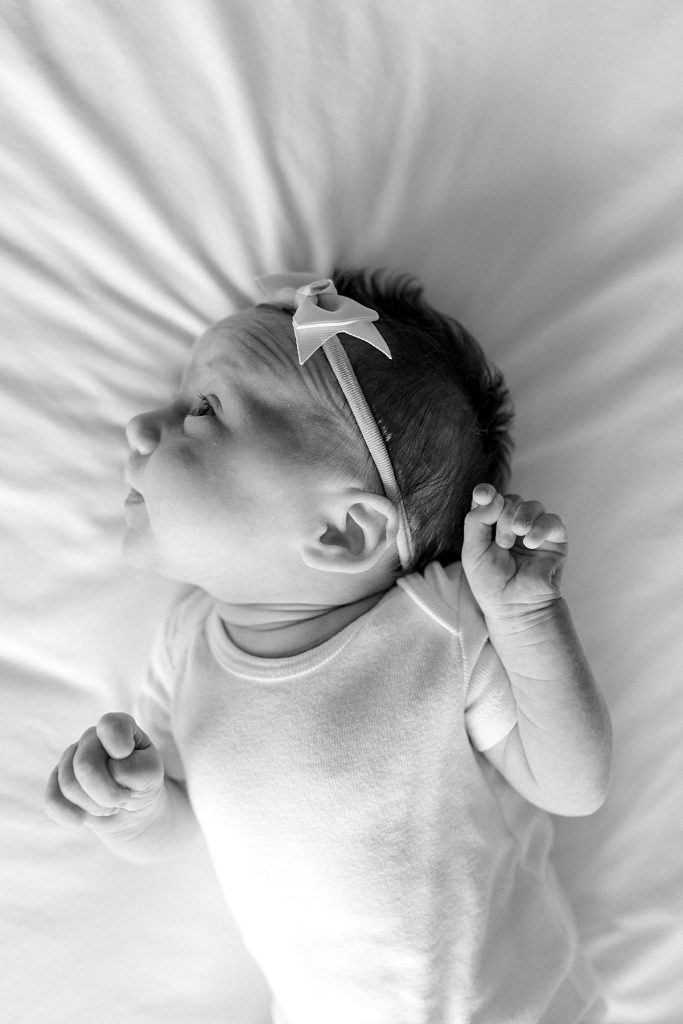 BW baby laying on bed in Newborn Family Session| Sabel Moments Photography 