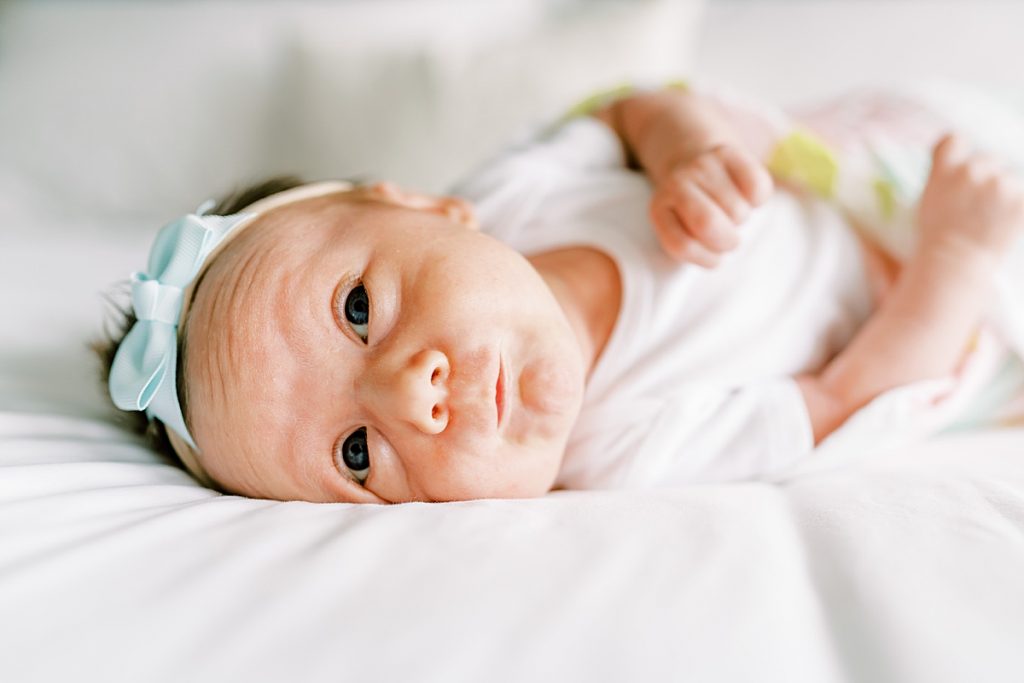 Baby laying on bed looking up| newborn| Sabel Moments Photography 