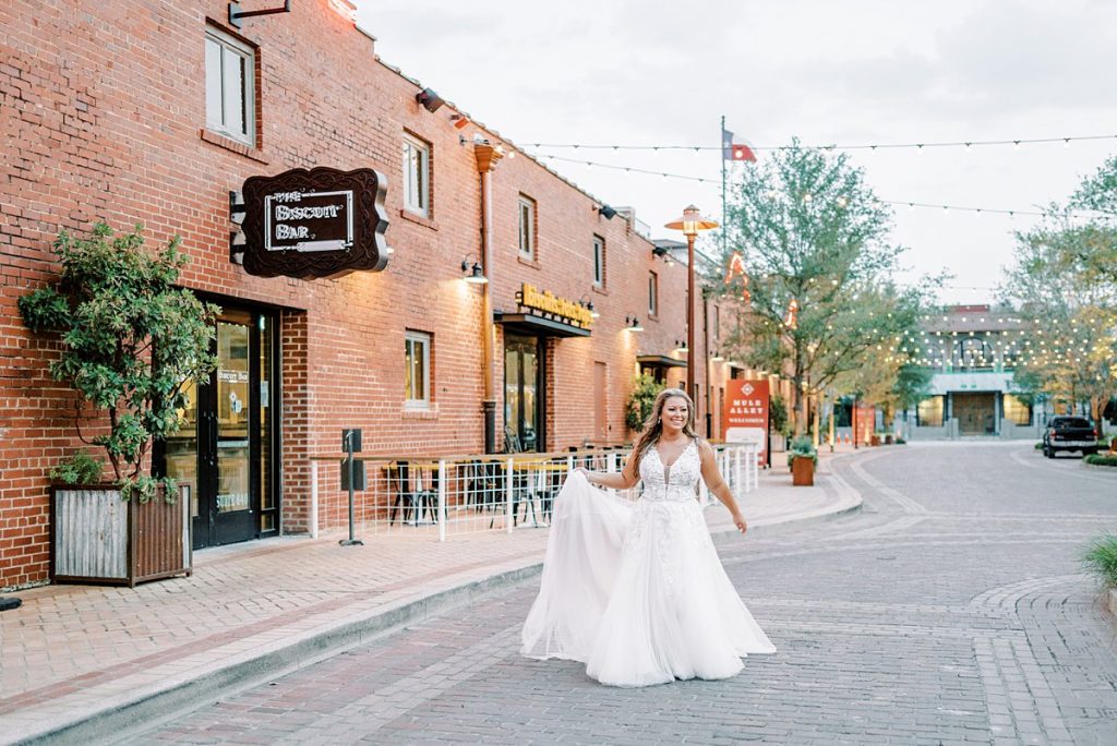 Bride walking through town square in  Fort Worth Stockyards bridal session