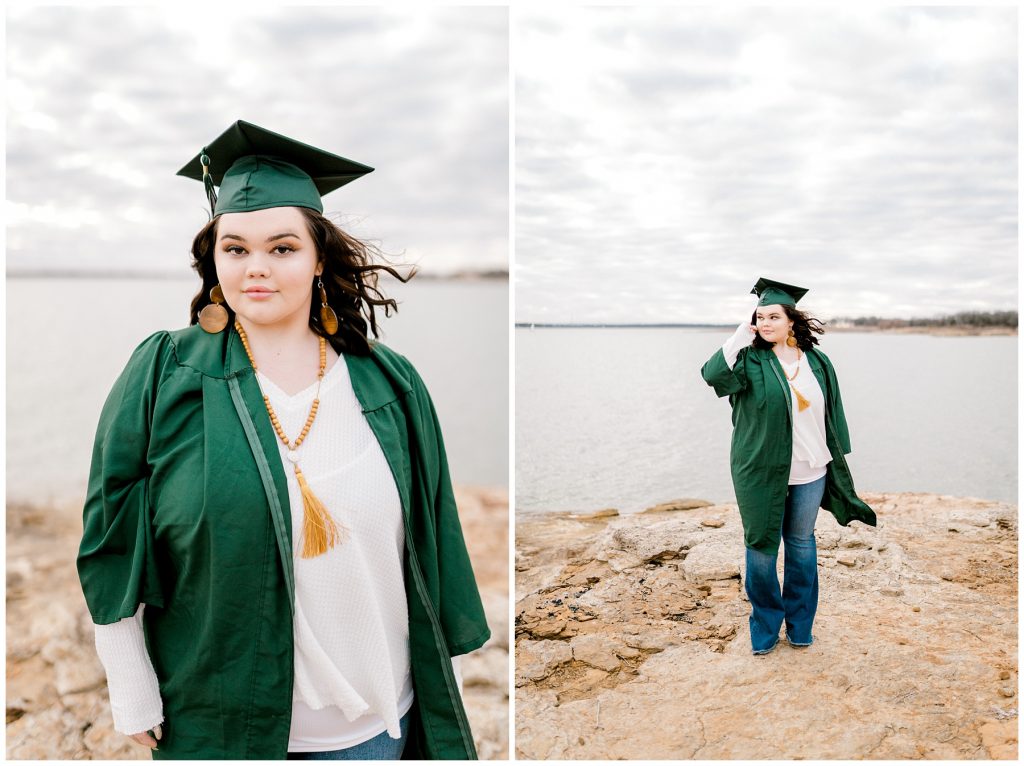 girl standing in cap and gown by lake