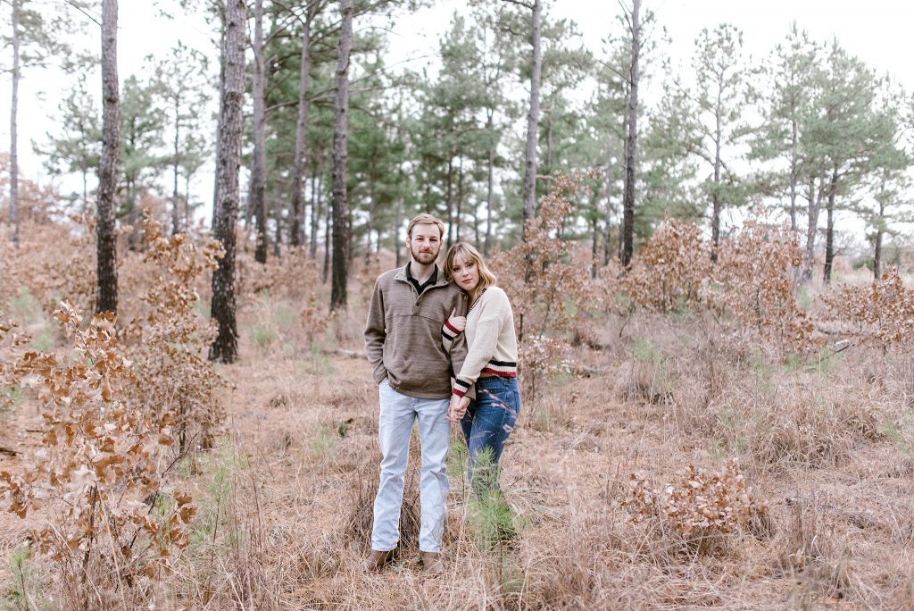 engagement photo with bride and groom in pine trees