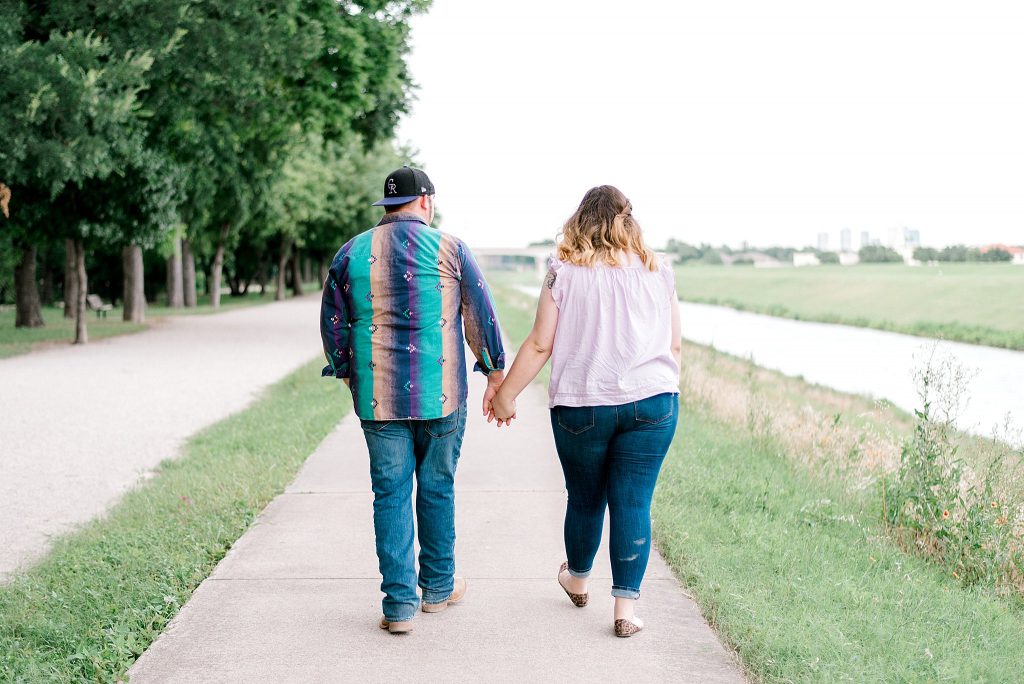 Fort Worth Engagement Session with couple walking beside the river