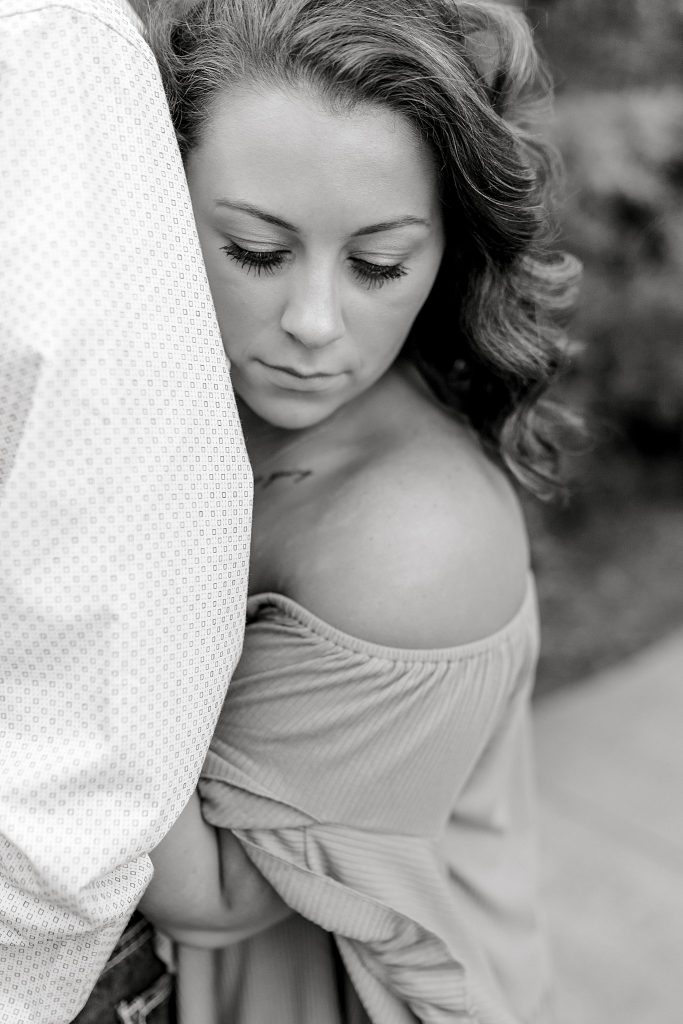 Bride looking down while hugging her groom | DFW Wedding Photographer