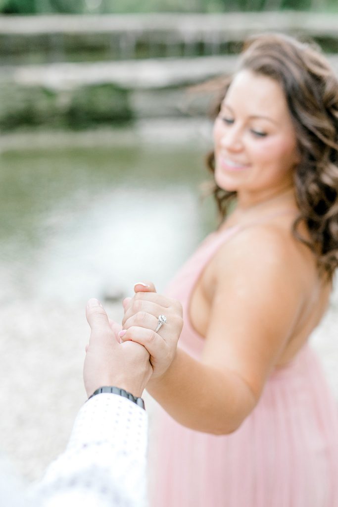 Bride is showing of her ring during their session