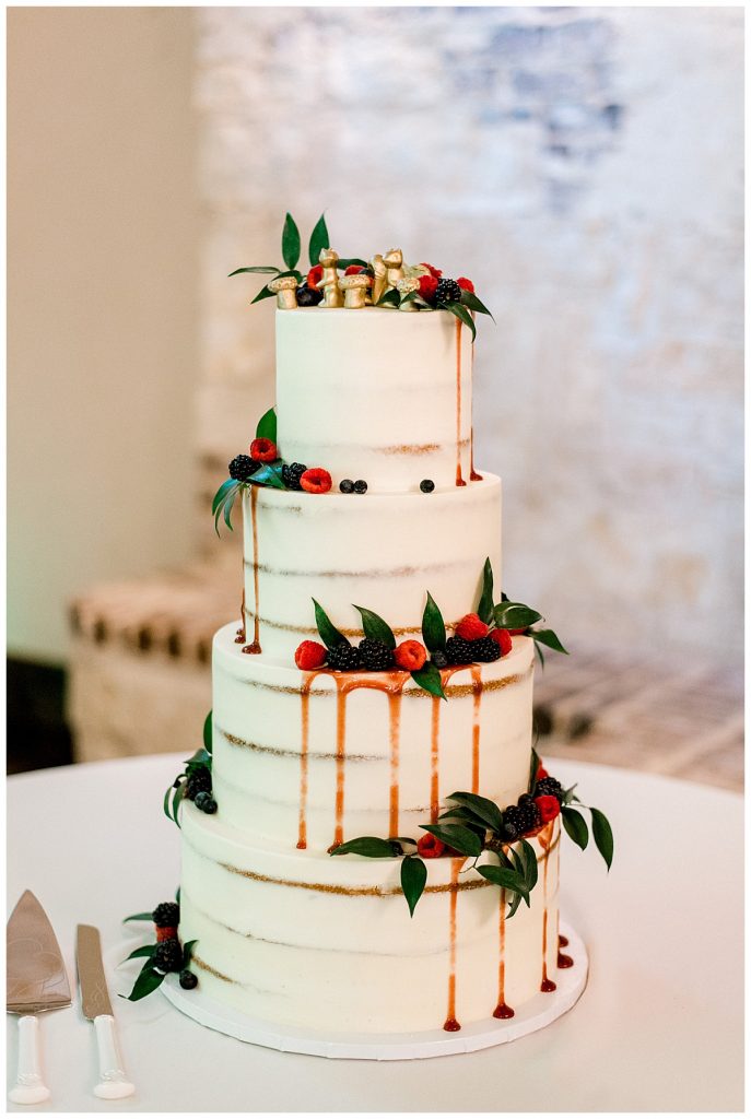 4 tiered shaved wedding cake with drips and fruit
