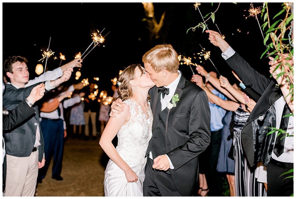 Bride and groom kiss wedding grand sparkler exit