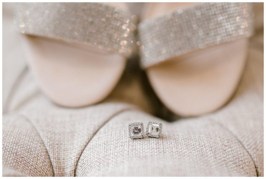 Square diamond earrings in front of wedding shoes