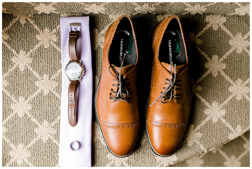 Grooms details- watch and wedding ring on tie and nuns bush shoes