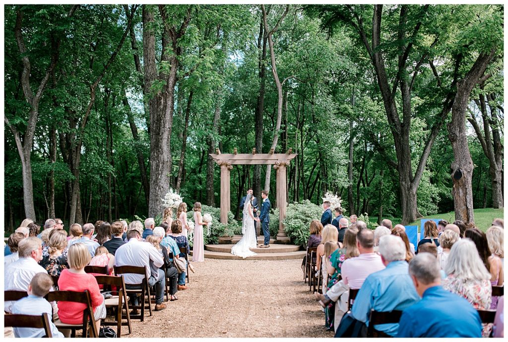 Bride and groom standing at alter| outdoor wedding at Hidden Waters Events