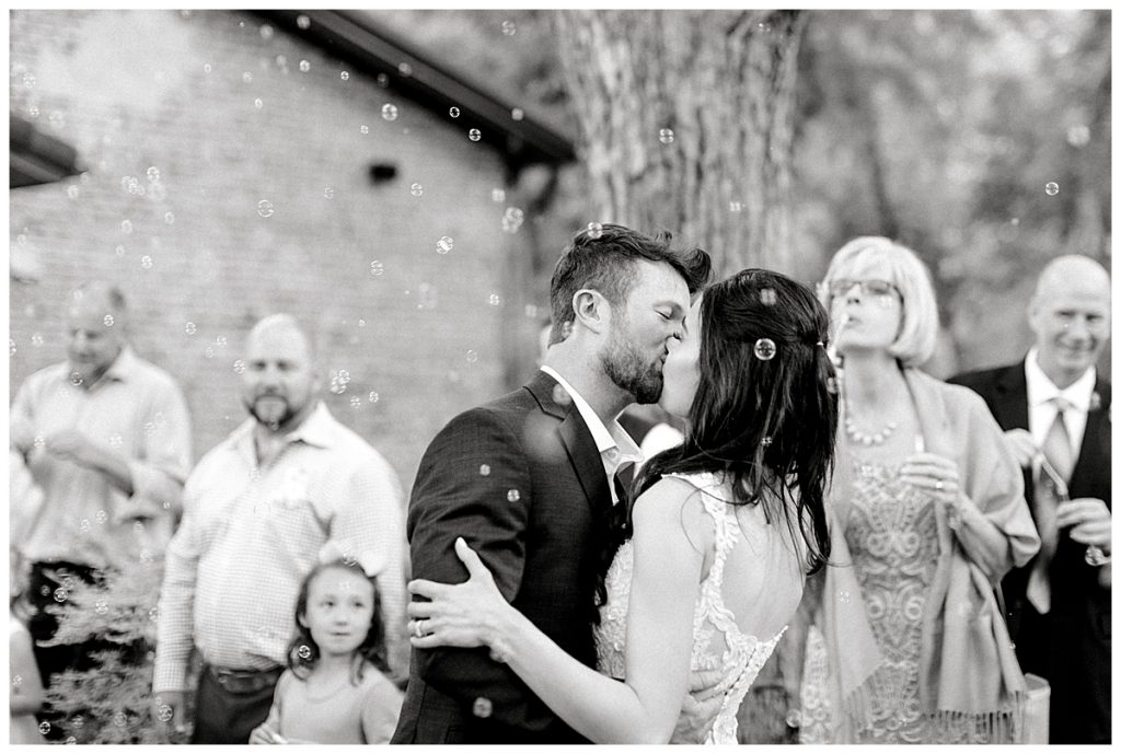 BW bride and groom kiss with bubbles