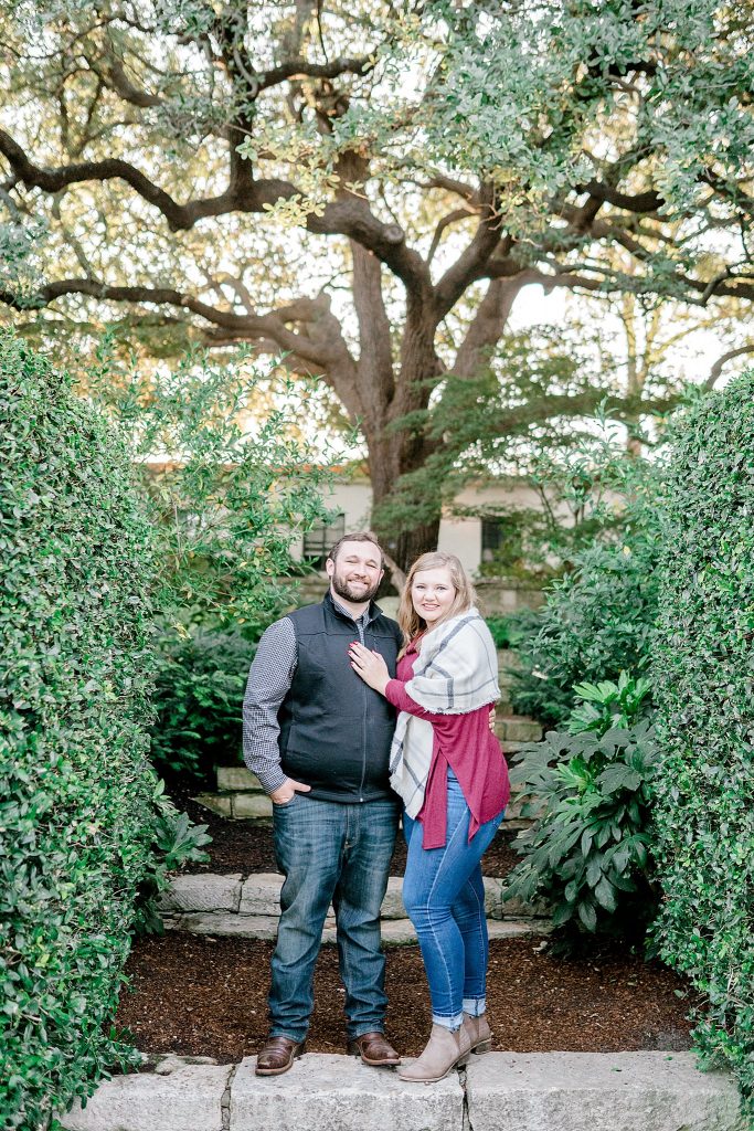 Bride and groom posing for the camera during their Dallas Arboretum Engagement Session