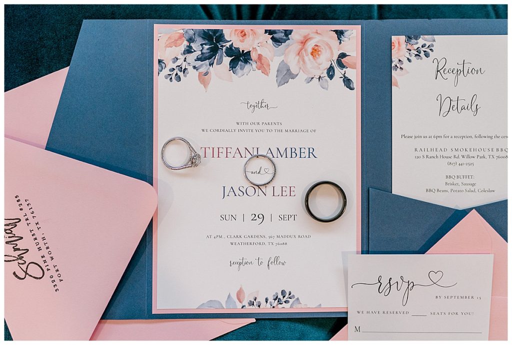 pink and blue wedding invitations with rings on top