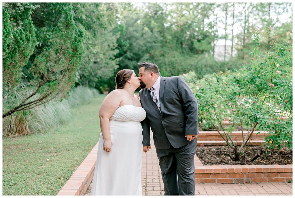 Bride and groom kissing at Clark Gardens Texas wedding venue