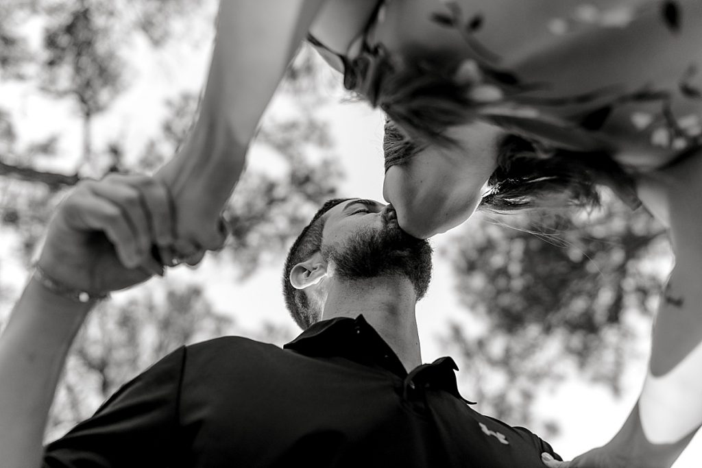 BW shot of guy and girl kissing from below