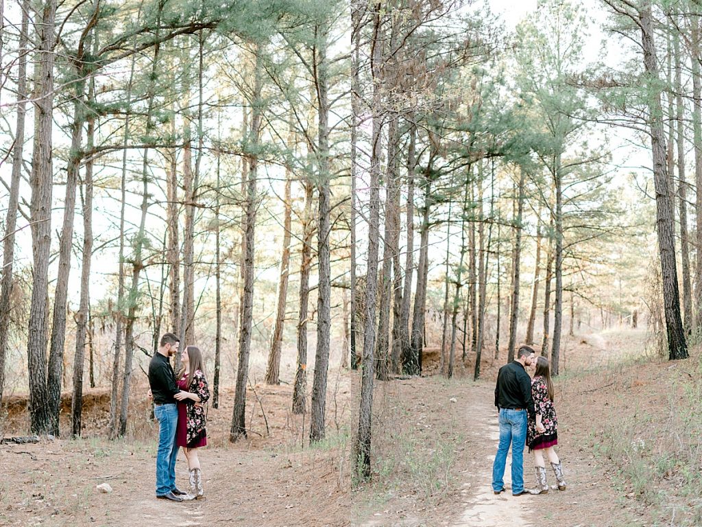 Couple kissing on woodsy path in a Wildcatter Ranch engagement session