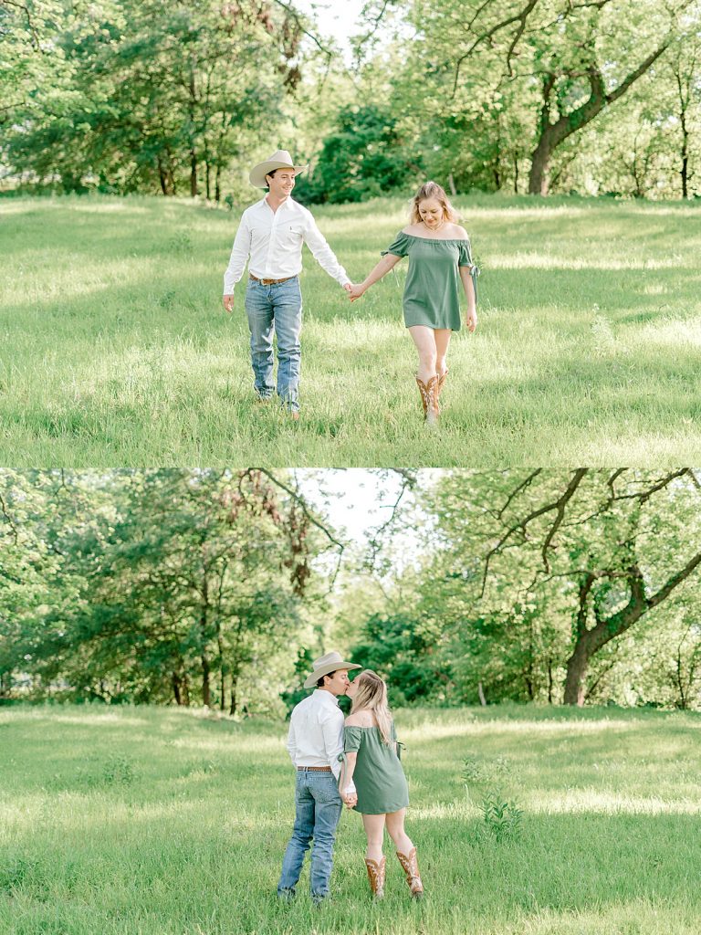 Couple holding hands walking and kissing in forest meadow