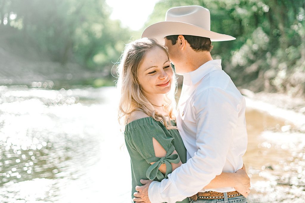 Couple hugging in sunlight at Hamilton engagement session