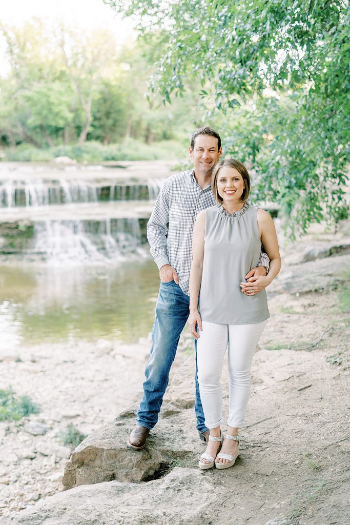 Couple standing on rock at Airfield Falls