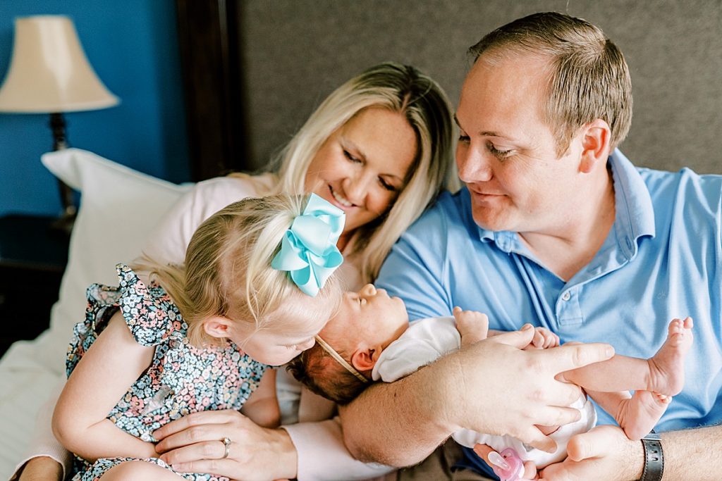 Big sister gives newborn kisses in Fort Worth Lifestyle Newborn Family Session