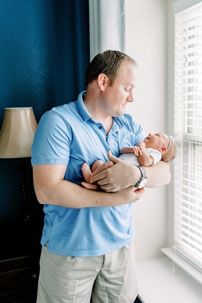 Father standing holding newborn | Sabel Moments Photography 