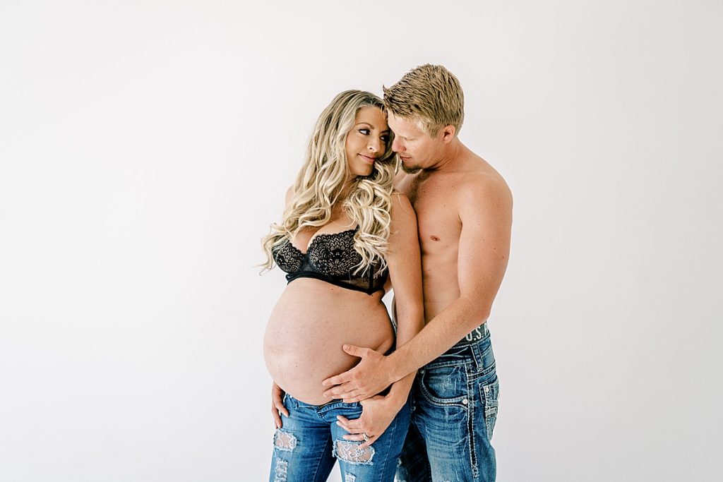 Husband and wife in embracing in Fort Worth maternity session