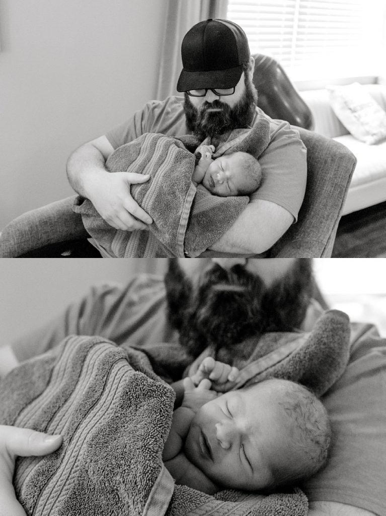 BW newborn baby being held by dad