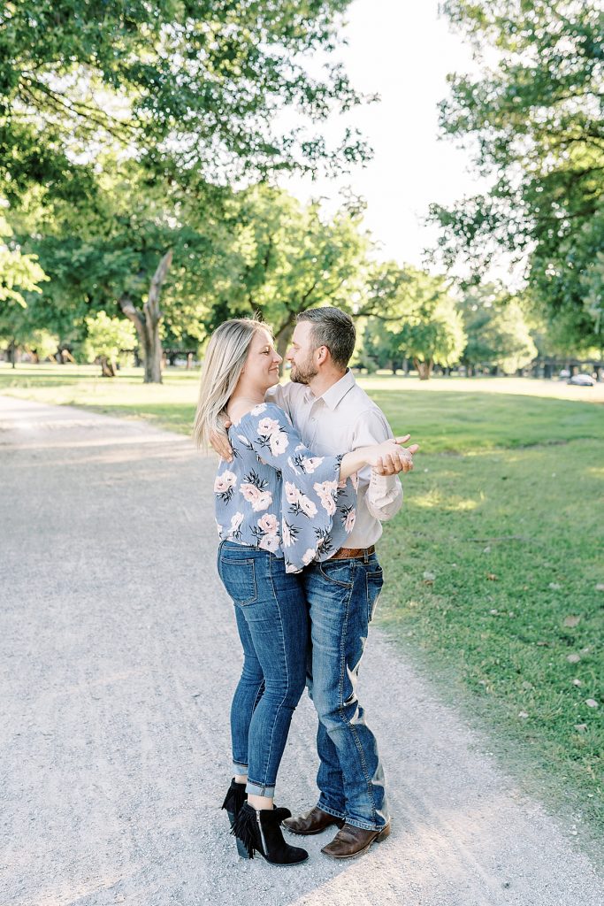 Couple dancing on gravel road in Trinity Park Fort Worth engagement session