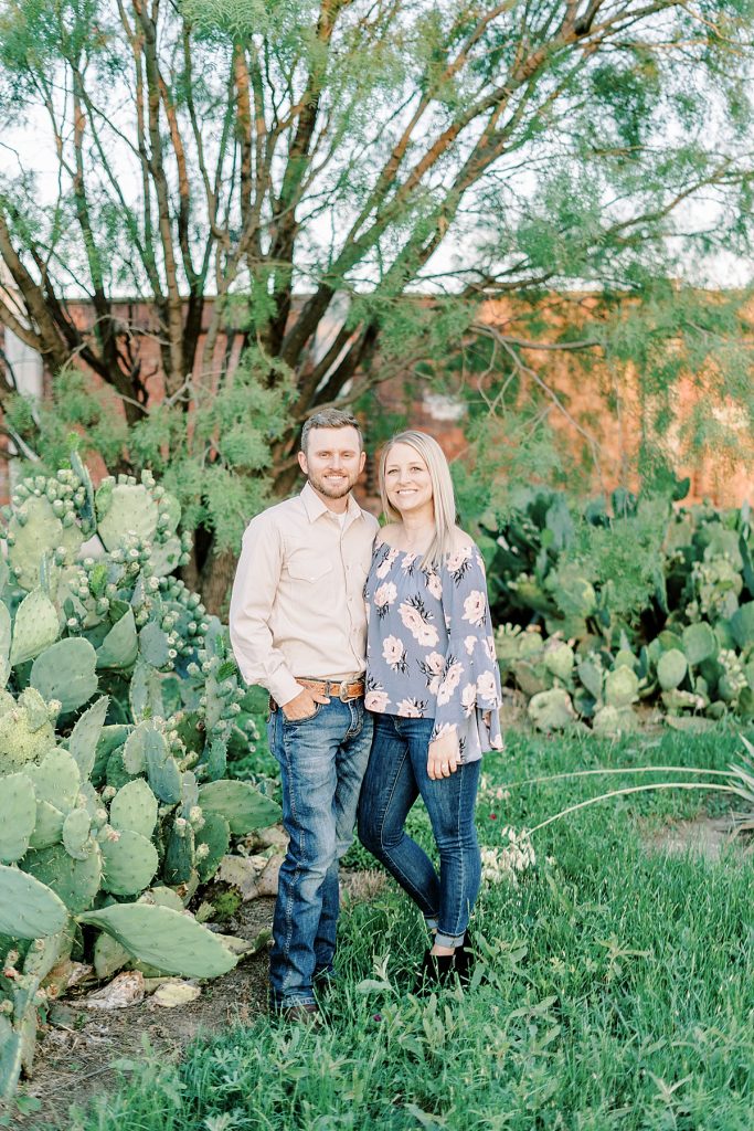 Couple standing in field of cacti in Fort Worth engagement