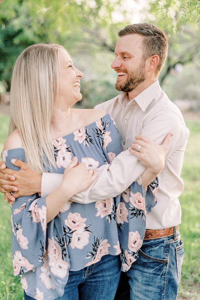 Engaged couple embracing and laughing