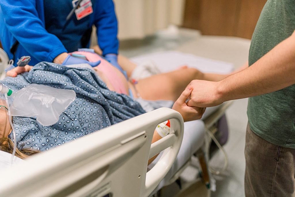 Husband holding wife's hand through contractions