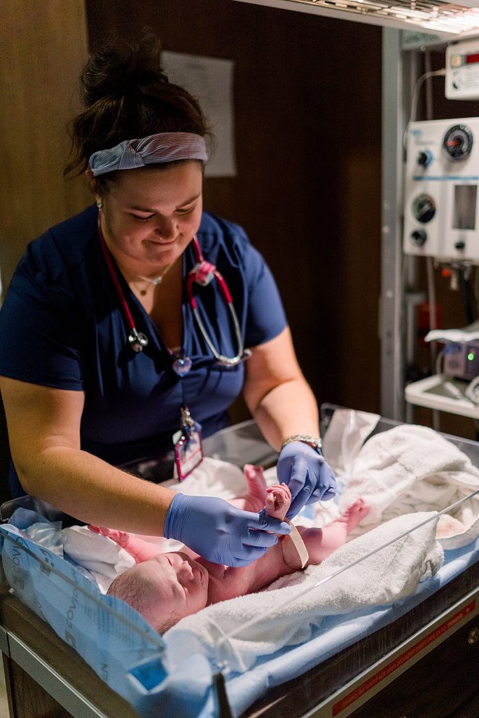 Nurse cleaning and measuring newborn for his Texas Health Natural Birth