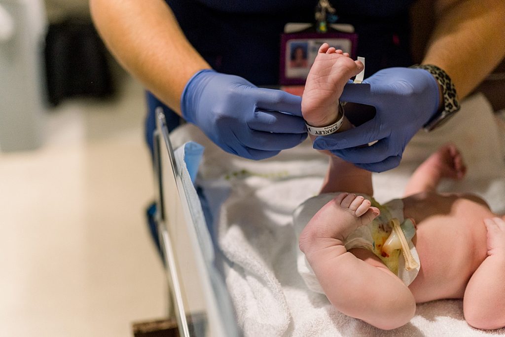 Newborn baby receiving anklet during his Texas Health Natural Birth