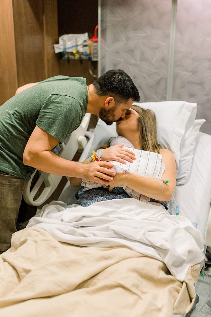 Parents kissing and swooning over newborn baby after their Texas Health Natural Birth