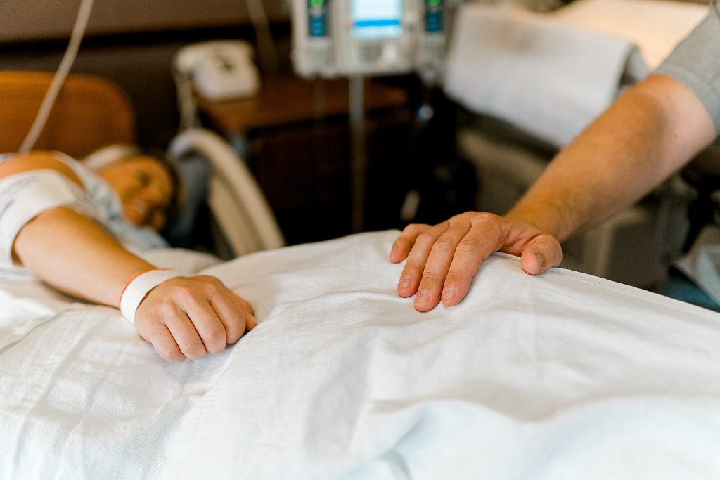 Husband laying hand on wife's leg during her contractions