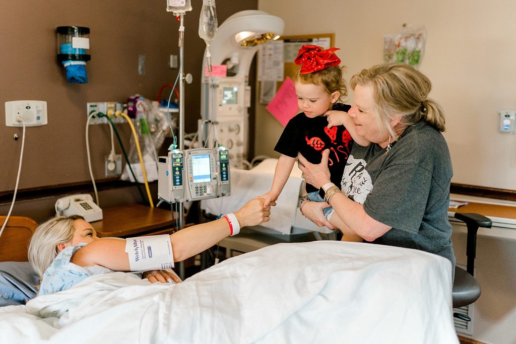 little girl holding her mother's hand at hospital during her Texas Health Harris Natural Birth