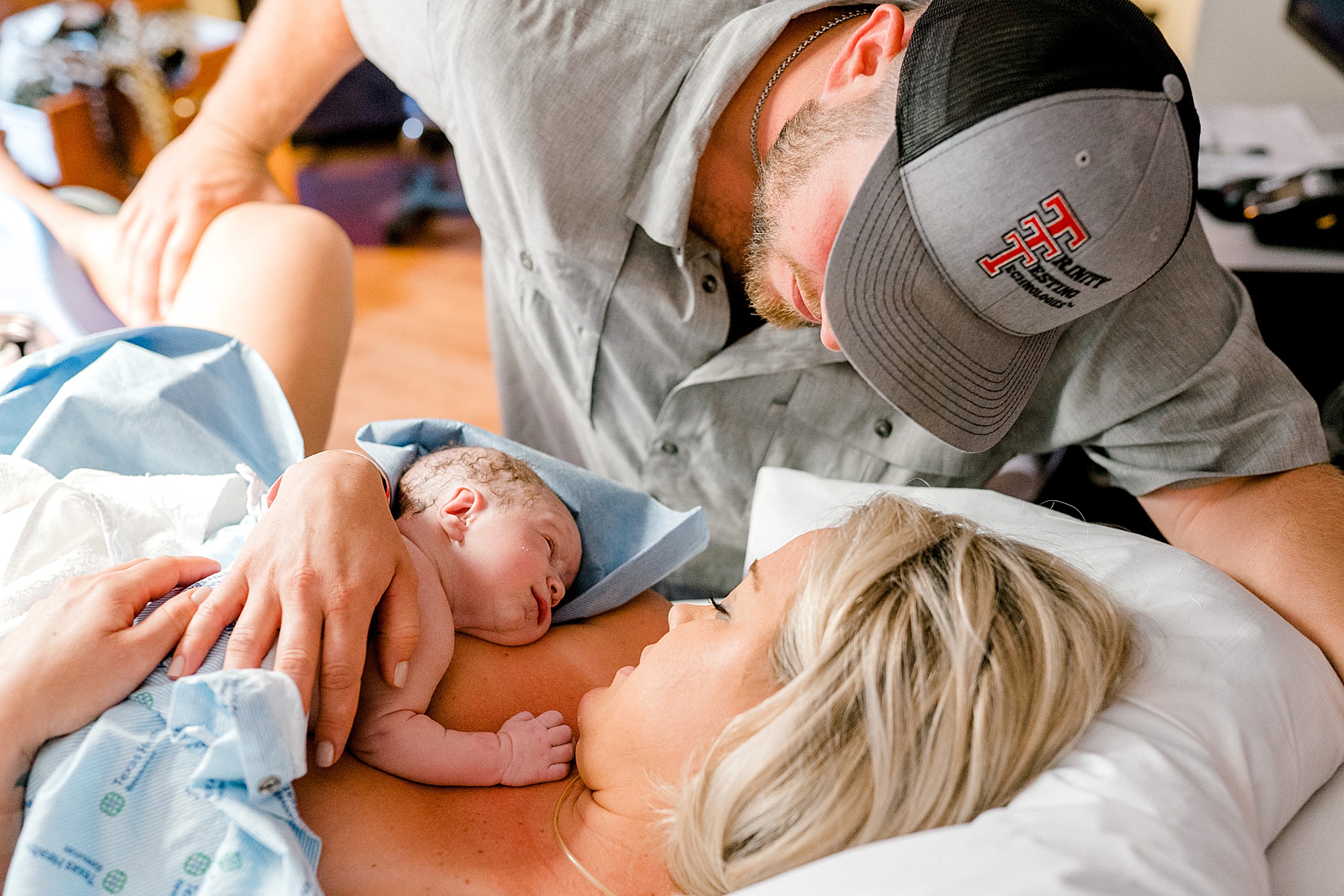 Mother and father swooning over newborn baby