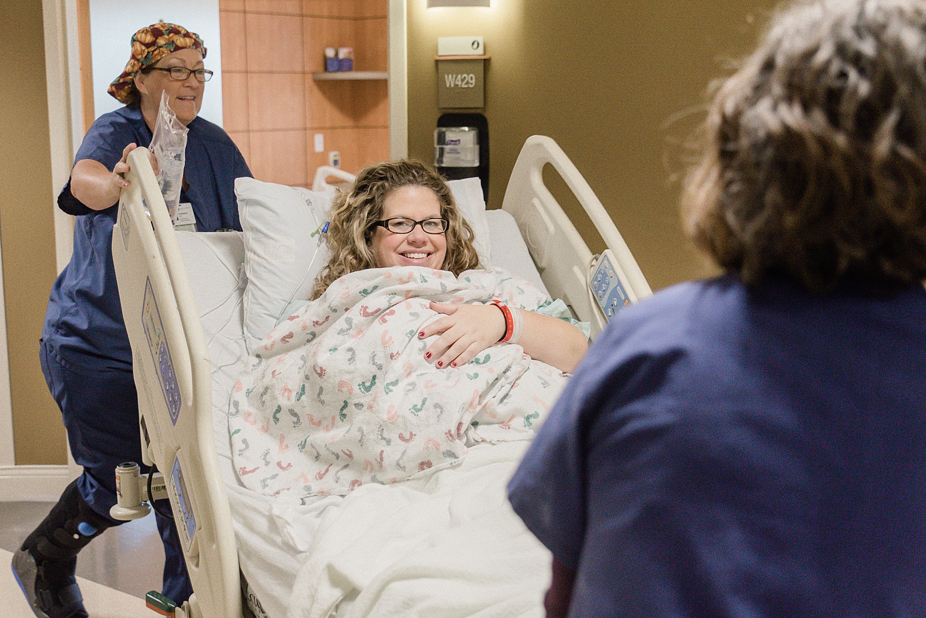New mother being wheeled into room after delivery