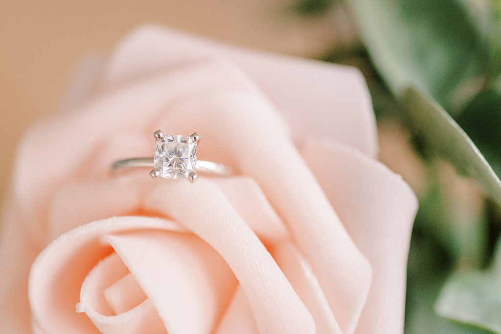 Solitaire wedding ring on pink rose