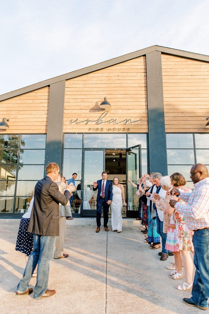 Wedding guests blow bubbles and see newly married couple off at Urban Fire House wedding