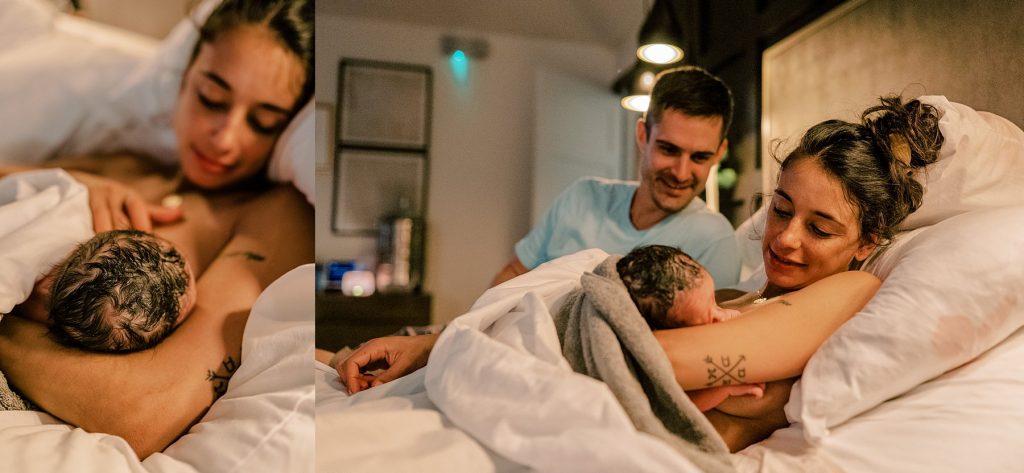 Parents swooning while mother nurses newborn in bed