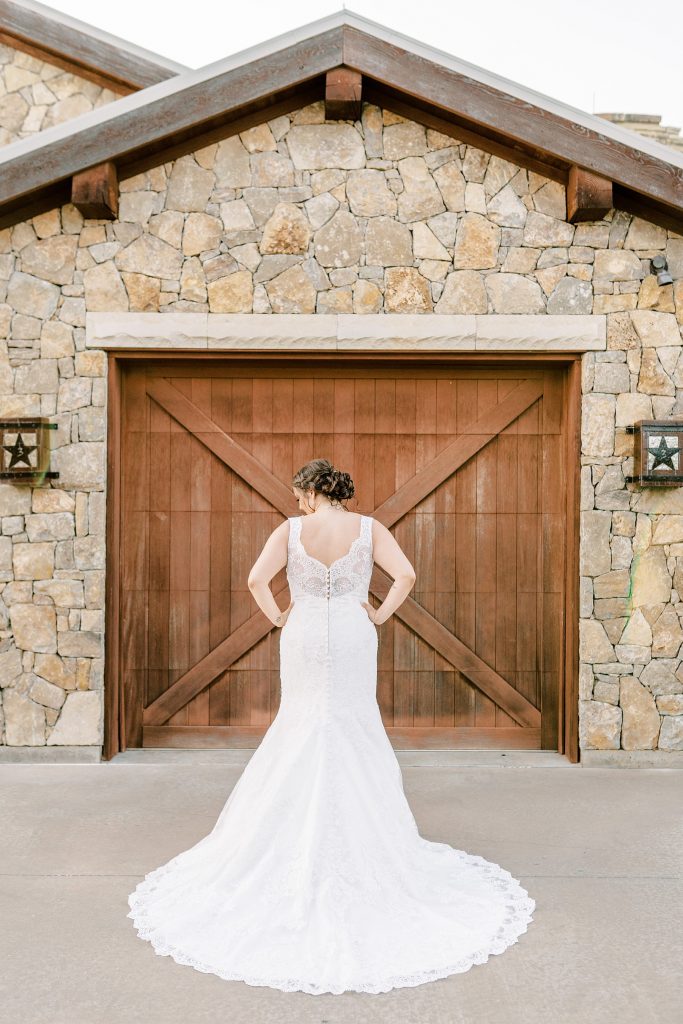 Backside of bride in button up lacy wedding gown
