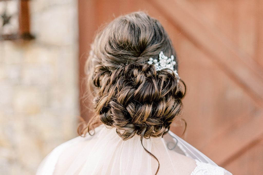 Beautiful braided bridal updo with crystal and pearl hairpin
