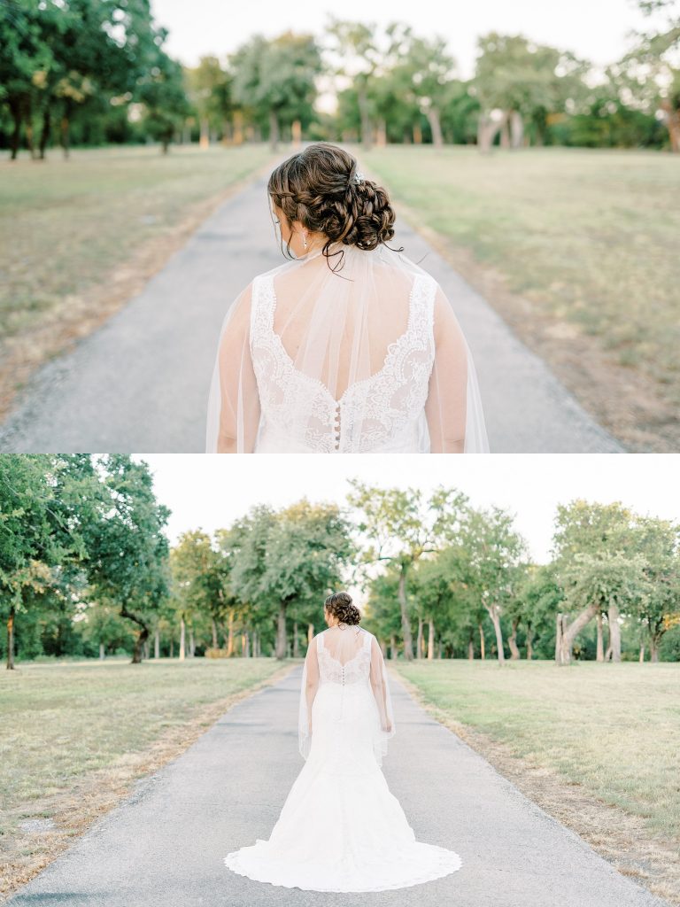 Bride standing in middle of road showing back of wedding gown