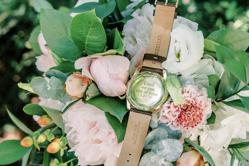 until we run out of time inscribed on back of watch laying in bridal bouquet