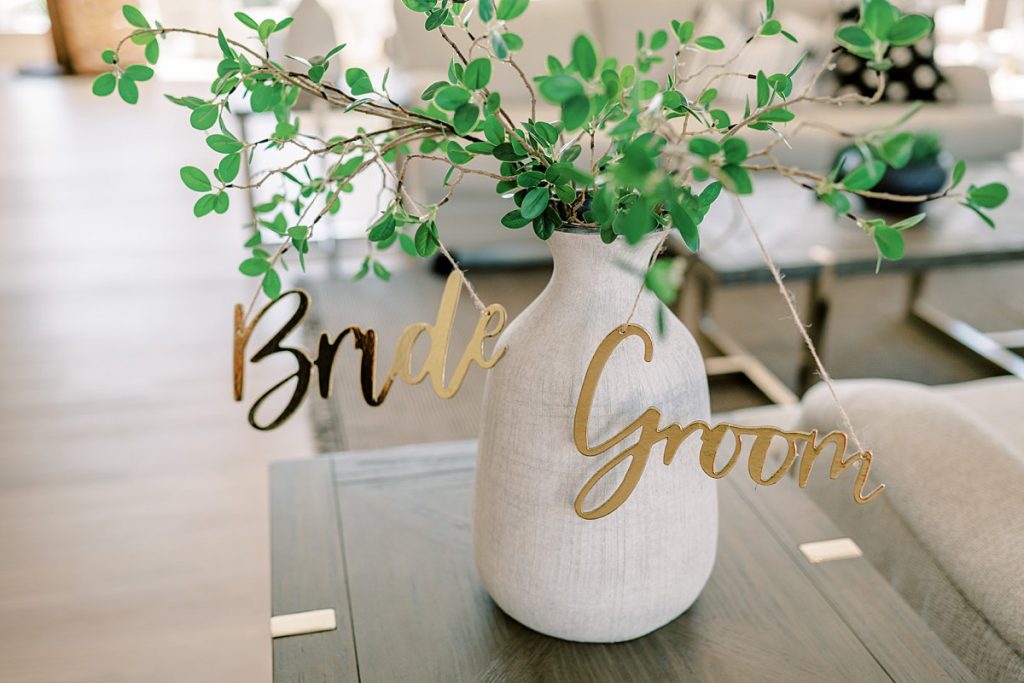 Bride Groom sign hanging from plant