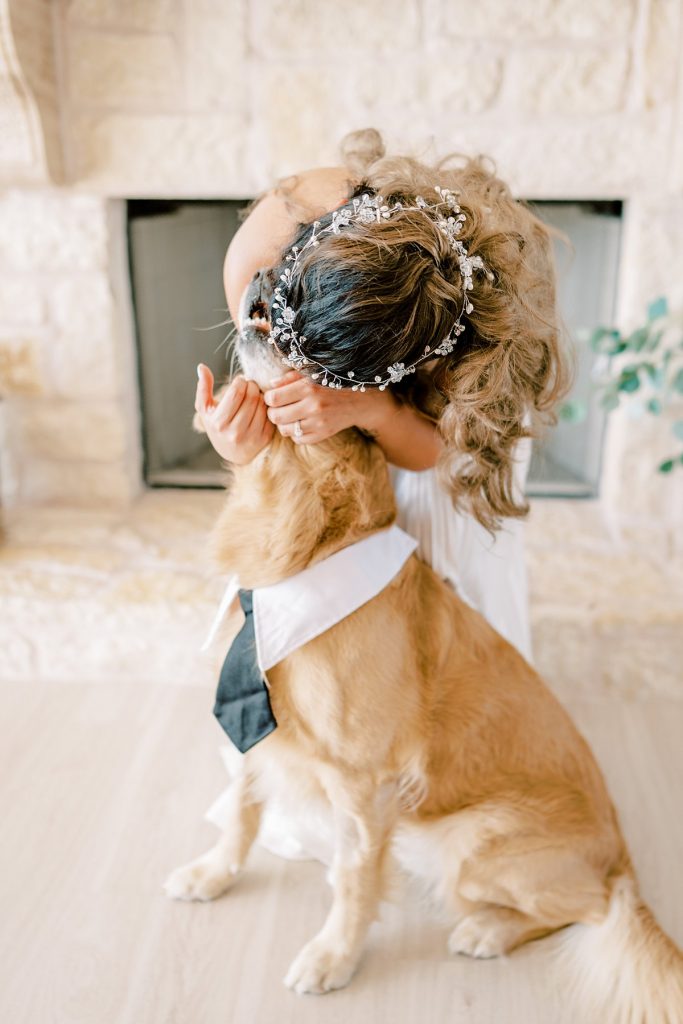 bride bending over kissing her dog