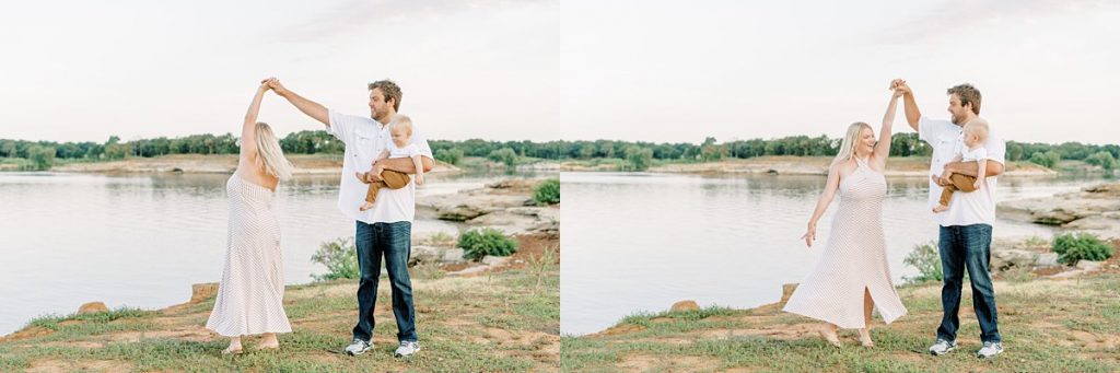 Father holding toddler and twirling wife by lake in summer family session